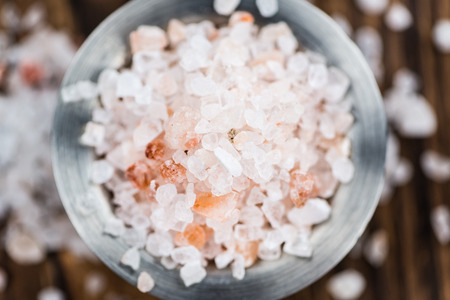 Himalayan Salt as high detailed close-up shot on a vintage wooden table (selective focus)の写真素材