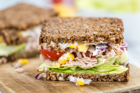 Tuna Sandwich (wholemeal bread; selective focus) on an old wooden tableの写真素材