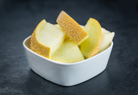 Fresh made Honeydew Melon on a vintage background (close-up shot)の写真素材