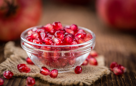 Pomegranate on a vintage background as detailed close-up shot (selective focus)の写真素材