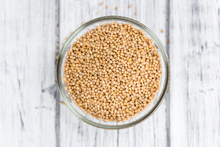 Mustard Seeds on a vintage background as detailed close-up shot (selective focus)の写真素材