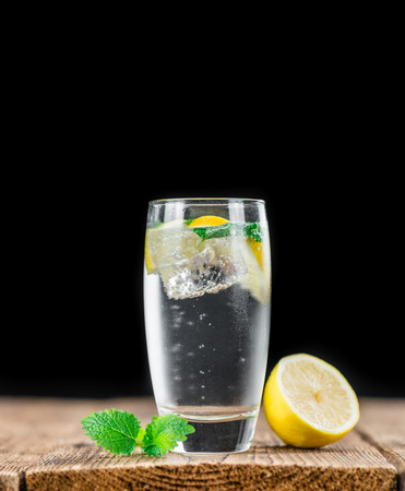 Lemonade (with Balm) as high detailed close-up shot on a vintage wooden table (selective focus)の写真素材