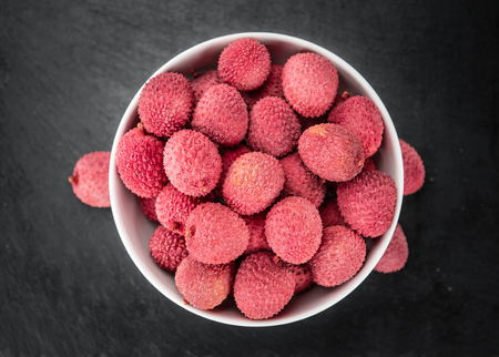 Portion of Litchis as detailed close up shot on a slate slab (selective focus)の写真素材