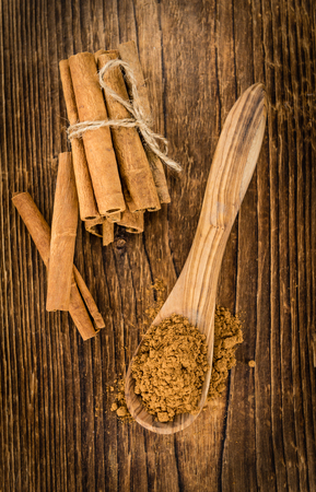 Cinnamon (ground) on an old wooden table as detailed close-up shot (selective focus)の写真素材