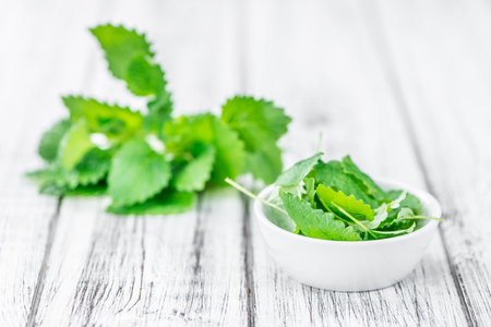 Melissa as high detailed close-up shot on a vintage wooden table (selective focus)の写真素材