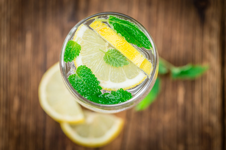 Homemade Lemonade on an wooden table (selective focus) as detailed close-up shotの写真素材