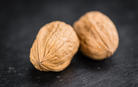 Walnuts on a vintage background as detailed close-up shot (selective focus)