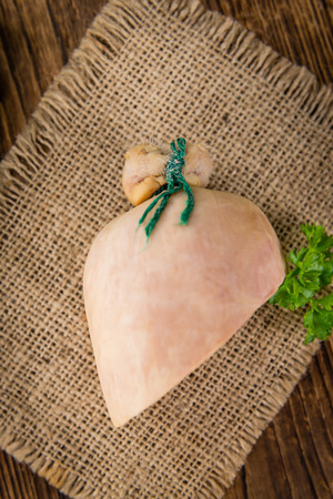 German Leberwurst on an old wooden table as detailed close-up shot (selective focus)の写真素材