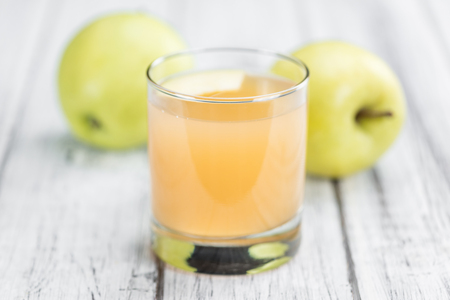 Apple Juice on a vintage background as detailed close-up shot (selective focus)の写真素材