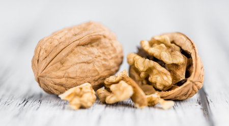 Walnuts on an old wooden table as detailed close-up shot (selective focus)の写真素材