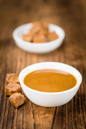 Portion of fresh Caramel Sauce (close-up shot; selective focus)の写真素材