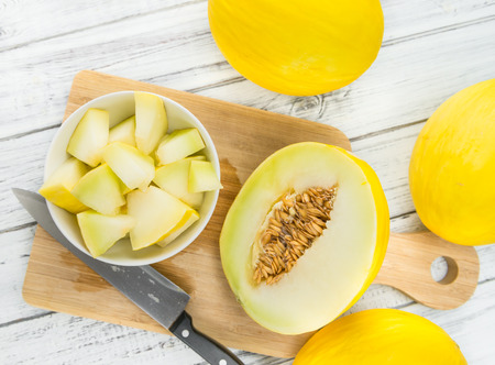 Fresh made Yellow Honeydew Melon on a vintage background (close-up shot)の写真素材