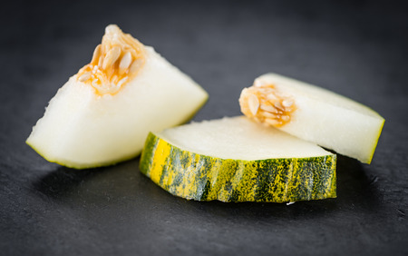 Portion of Futuro Melons as detailed close up shot on a slate slab (selective focus)の写真素材