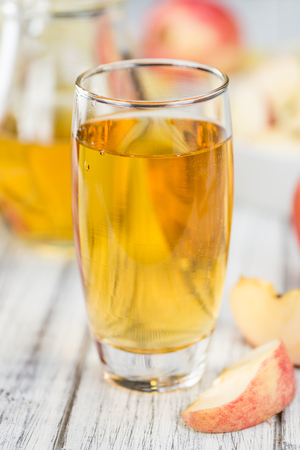 Apple Cider on an old wooden table as detailed close-up shot (selective focus)の写真素材
