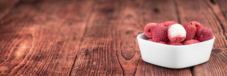 Litchis on an old wooden table as detailed close-up shot (selective focus)の写真素材