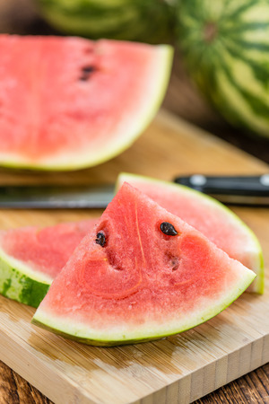 Fresh Watermelon as high detailed close-up shot on a vintage wooden table (selective focus)の写真素材