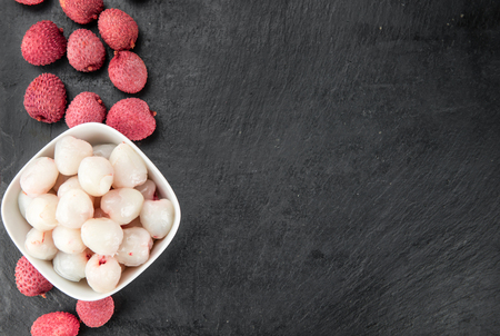 Portion of Litchis as detailed close up shot on a slate slab (selective focus)の写真素材