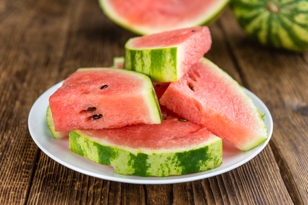 Fresh Watermelon as high detailed close-up shot on a vintage wooden table (selective focus)の写真素材