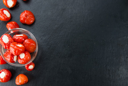 Portion of Filled Pimientos as detailed close up shot on a slate slab (selective focus)の写真素材