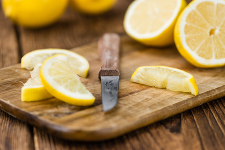 Fresh made Lemon (sliced) on a vintage background (close-up shot)の写真素材