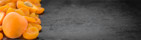 Dried Food (Apricots) on a vintage slate slab (close-up shot; selective focus)の写真素材
