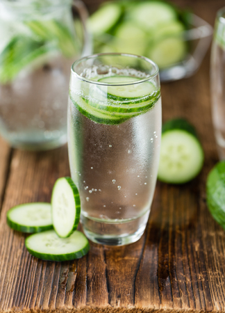 Cucumber Water on rustic wooden background as close-up shotの写真素材