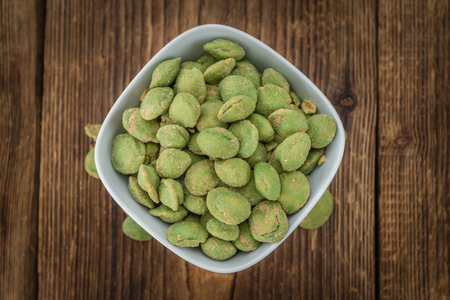 Wasabi Peanuts on a vintage background as detailed close-up shot (selective focus)の写真素材
