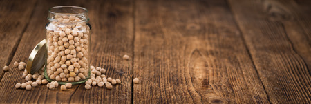 Chickpeas on an old wooden table as detailed close-up shot; selective focusの写真素材