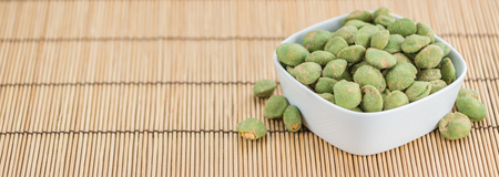 Wasabi Peanuts on a vintage background as detailed close-up shot (selective focus)の写真素材