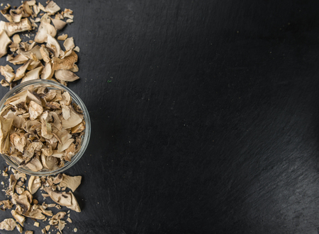 Dried Mushrooms (Agaricus) on a vintage slate slab as detailed close-up shot; selective focus