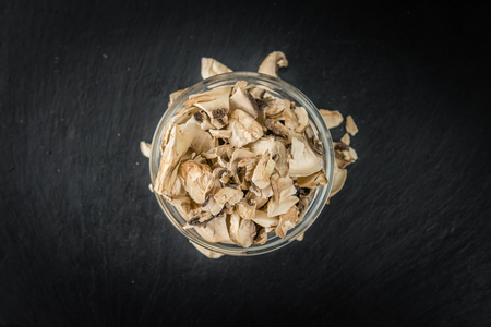 Some Dried white Mushrooms on a vintage slate slab, selective focusの写真素材