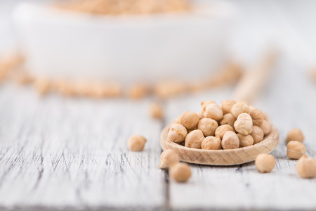 Dried Chickpeas as high detailed close-up shot on a vintage wooden table; selective focusの写真素材