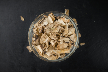 Dried Mushrooms (Agaricus) on a vintage slate slab as detailed close-up shot; selective focusの写真素材