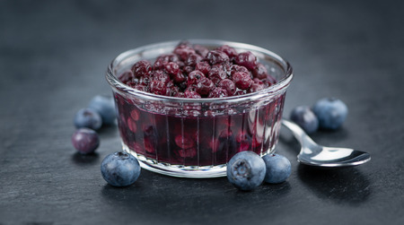 Some fresh Preserved Blueberries on a vintage slate slab, selective focus, close-up shotの写真素材