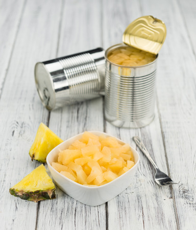 Preserved Pineapple pieces on a vintage background as detailed close-up shot, selective focusの写真素材