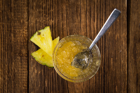 Fresh made Pineapple Jam on an old and rustic wooden table; selective focus; close-up shotの写真素材