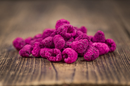 Fresh made Raspberries (dried) on an old and rustic wooden table; selective focus; close-up shotの写真素材