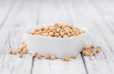 Chickpeas on an old wooden table as detailed close-up shot; selective focusの写真素材