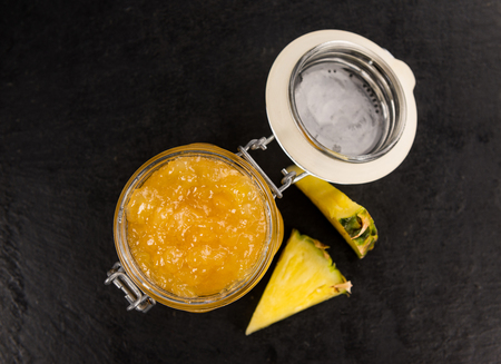 Portion of Pineapple Jam on a rustic slate slab, selective focus, close-up shotの写真素材