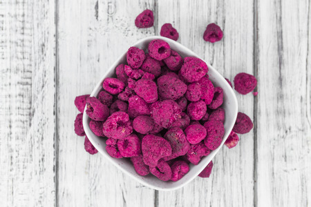Fresh made Raspberries (dried) on an old and rustic wooden table; selective focus; close-up shotの写真素材