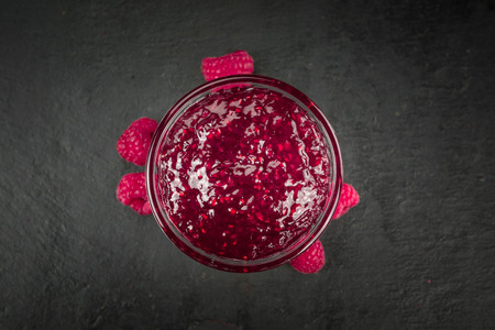 Fresh made Raspberry Jam on a vintage background as detailed close-up shotの写真素材