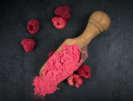 Ground Raspberries on a vintage slate slab as detailed close-up shot; selective focusの写真素材