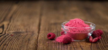 Ground Raspberries on an old wooden table as detailed close-up shot; selective focusの写真素材