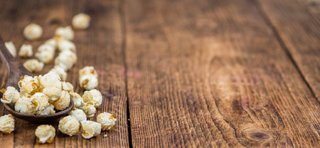 Fresh made Popcorn on a vintage background as detailed close-up shotの写真素材