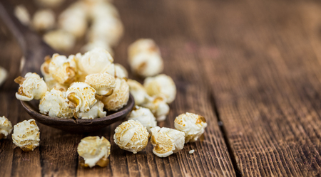 Popcorn as high detailed close-up shot on a vintage wooden table; selective focusの写真素材
