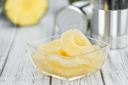 Fresh made Preserved Pineapple Rings on a vintage background as detailed close-up shotの写真素材
