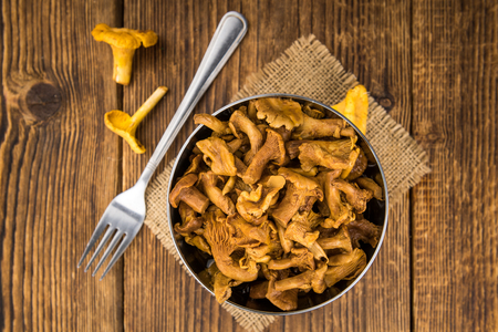 Canned chanterelles on a vintage background as detailed close-up shot, selective focusの写真素材