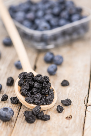 Dried Blueberries as high detailed close-up shot on a vintage wooden table; selective focusの写真素材