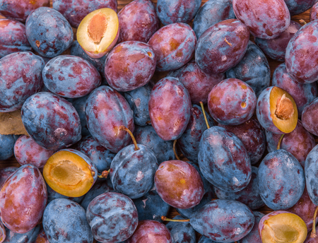 Plums on a vintage background as detailed close-up shot, selective focusの写真素材