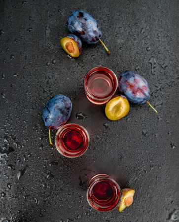 Plum Liqueur on a vintage slate slab as detailed close-up shot; selective focusの写真素材